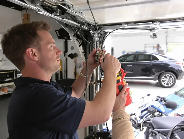 Milford Garage Door Repair safety certified technician performing cable replacement in Milford